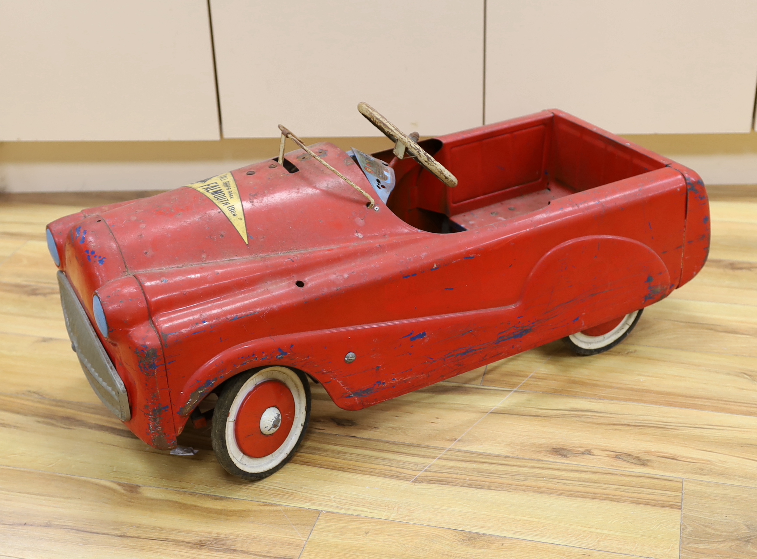 A Sebel tinplate pedal car circa 1960, 90cm long (a.f.)